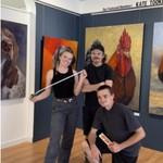 Rooster paintings being hung